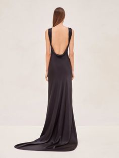 the back of a woman wearing a long black dress