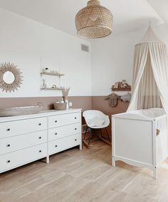 a baby's room with a crib, dresser and changing table in it