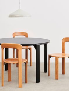 the table and chairs are all made out of wood, with one chair up against the other