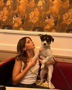 a woman holding a small dog in her lap