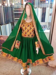 Folk Style Embroidered Dress With Traditional Drape, Fitted Embroidered Dress With Traditional Multicolor Patterns, Fitted Embroidered Dress With Multicolor Traditional Patterns, Bohemian Green Dresses With Dabka Work, Green Bohemian Dresses With Dabka Work, Green Ceremonial Dress For Festivals, Traditional Embroidered Fitted Dress, Multicolor Embroidered Dress With Mirror Work, Fitted Folk Embroidered Dress For Traditional Ceremonies