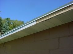 the roof of a house with trees in the background