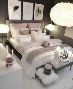 a bed room with a neatly made bed and lots of pillows