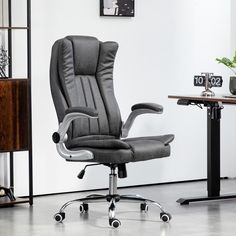 an office chair sitting in front of a desk with a clock on the wall behind it