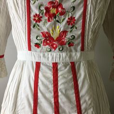 "This dress is so special. It is a vintage 60s/70s Mexican pin tucked white dress. The dress has a square neckline, that is trimmed with red ribbon and small lace ruffles, is fitted to the waist with a floral embroidered bodice that is also finished on the side with red ribbon, it has 3/4 sleeves with a flared lace cuff and red ribbon trim, The skirt is a long maxi skirt that is quite full, it has a front and back center panel with red ribbon running down the length, coming off the front panel i Spring Fitted Maxi Dress With Intricate Embroidery, Spring Maxi Dress With Intricate Embroidery, White Fitted Embroidered Dress For Wedding, Cream Cotton Dress With Intricate Embroidery, Fitted Vintage White Dress With Lace Patchwork, Folk Style Embroidered Fitted Maxi Dress, White Floral Embroidered Vintage Dress, Fitted Cottagecore Dress With Lace Work, Fitted White Vintage Dress For Spring