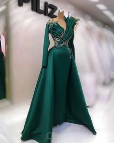 Elevate your evening ensemble with this stunning floor-length dark green gown, an epitome of elegance and sophistication. The dress features a unique asymmetric design with a single long sleeve, beautifully merging classic and contemporary styles. Intricate embellishments cascade down from the shoulder, creating a striking focal point that adds a touch of glamour to your look.Crafted from high-quality fabric, this gown not only promises an exquisite appearance but also ensures comfort throughout Ashoebi Gowns, Dark Green Gown, American Prom, Engagement Gowns, Sequin Prom Dress, Green Gown, Pretty Prom Dresses, Green Prom Dress, Evening Formal