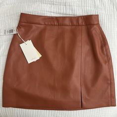 Aritzia Wilfred Vegan Leather Mini Skirt With Slit, Style Name “Tempest”, Cinnamon Brown Color, Size 4, Nwt Green Leather Skirt, Plaid Tennis Skirt, Pink Denim Skirt, Aritzia Skirt, Brown Leather Skirt, Olive Skirt, Mini Pleated Skirt, Mini Wrap Skirt, Navy Blue Skirt