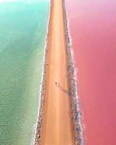 an aerial view of the beach with pink water and sand on it's sides