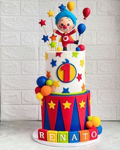 a birthday cake decorated with clowns and stars