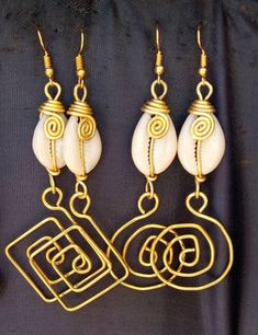 The earrings are  made with a lot of love and care from cowries and brass.   The wire is coiled to give a stunning look.  The are  beautifully designed for you, sister, mother, relative or a friend. The are light in weight and comfortable to wear. **This listing is for two pairs of earrings.** Buy multiple items pay shipping for one the rest ships free. Custom orders are welcome. For more earrings, follow the link. https://www.etsy.com/listing/697317594/african-earrings-gift-for-her-earrings?ref=related-1 **Happy shopping** Dhl shipping express Thank you. Handmade Cowrie Shell Earrings For Gift, Handmade Cowrie Shell Earrings As Gift, Gold Cowrie Shell Earrings As Gift, Gold Cowrie Shell Earrings For Gift, Cowrie Shell Dangle Jewelry Gift, Cowrie Shell Dangle Jewelry For Gifts, Gold Cowrie Shell Jewelry For Gift, Unique Gold Shell Earrings, Unique Gold Earrings For Beach