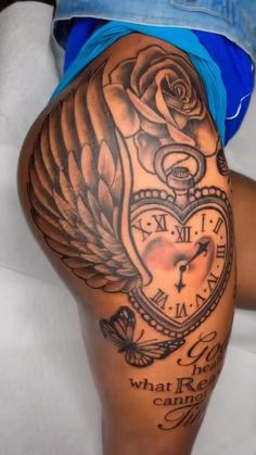 a woman's thigh with tattoos on it and an angel clock in the middle