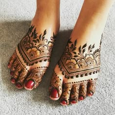 the feet are decorated with henna designs