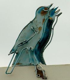 a metal bird on top of a building