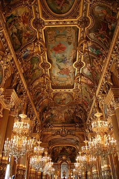 an ornate room with chandeliers and paintings on the ceiling