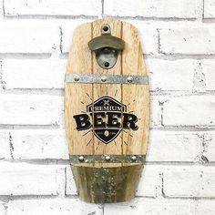 a wooden beer keg hanging on a brick wall next to a white brick wall