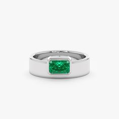 Geneva Unveil your bold style with the Off-Center Emerald Statement Ring. This eye-catching ring showcases a vibrant natural emerald, the May birthstone, in a captivating off-center setting. Crafted in lustrous 14k or 18k solid gold, the thick band adds a contemporary touch while maintaining minimalist elegance. - Handmade- Solid Gold- Natural Emerald- Total Emerald Carat Weight: 0.49 ctw- The Height of the Setting: 2.93 mm- Width of the Setting with the Band: 7.12 mm- The Width of the Band: 5.7