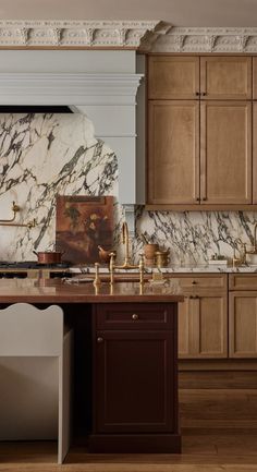 a kitchen with marble counter tops and wooden cabinets, along with an island in the middle