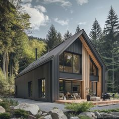 a modern house in the woods surrounded by rocks