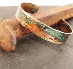 Our copper cuff is hand forged from rich jewelers bronze. Cuffs are hammered for texture and then aged in an organic solution to give it a verdigris patina. The aging process creates a different, unique patina on each piece. No two bracelets are exactly alike. A true one of a kind just like you.The Date of your choice is hand stamped into the bracelet.Copper is the traditional gift for the 7th and 22nd anniversary.*SIZING*The circumference of each cuff is the size in inches plus a 1.25" to 1.5" Mens Copper Bracelet, 19th Anniversary Gifts, Personalized Cuff Bracelets, Roman Numerals Dates, Roman Numeral Bracelet, 22nd Anniversary, Hammered Cuff Bracelet, Copper Bracelets, Copper Anniversary