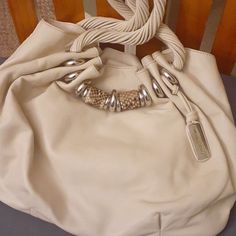 Pre-Owned Handbag With Tags In Excellent Condition No Odor Or Rips Comes From A Smoke Free Home Middle Zipper Compartment Zipper Pocket And Slip In Pockets Color Is White Beige Shopping Bags With Palladium Hardware, Cream Bag With Palladium Hardware And Double Handle, Cream Double Handle Bag With Palladium Hardware, Designer Michael Kors Shoulder Bag With Leather Handles, Designer Cream Bag With Braided Handles, Designer Cream Bags With Braided Handles, Cream Tote Shoulder Bag With Palladium Hardware, Michael Kors Leather Bags With Silver-tone Hardware, Luxury Michael Kors Shoulder Bag With Leather Handles