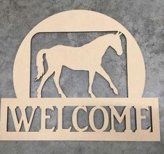 a sign that says welcome with a horse