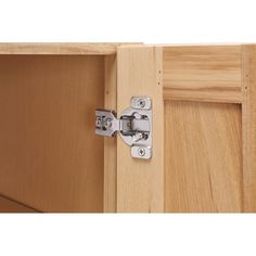 a close up view of an open cabinet door with metal latches on the side