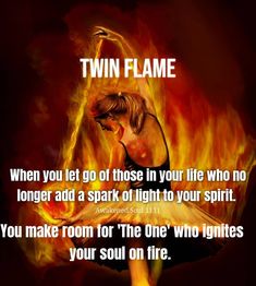 a woman sitting in front of a fire with the words twin flame