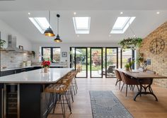 an open kitchen and dining room with skylights