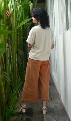 These unisex ankle-length trousers, made of a breathable cotton linen, are an elegant, comfy wardrobe essential. With an elastic back, smooth tied front and back patch pockets, they are easy and chic - perfect for casual outings and summer evenings. Handmade in our fair trade workshop in Bali. Andrea designs each of our relaxed, versatile pieces to be part of a classic, timeless, minimalist wardrobe.100% Cotton linen - Hand or machine wash cold, tumble dry on low heat or line dry.—Size Guide—S - Comfy Wardrobe, Pants Cotton, Minimalist Wardrobe, Summer Evening, Cayman Islands, Equatorial Guinea, British Indian, Brunei, Caribbean Netherlands