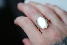 Mother of Pearl set in 14k gold-filled. High polish finish. Available in any size. Listing for matching thick gold-filled stacking ring: https://www.etsy.com/listing/1028176938/thick-gold-stacking-ring-gold-filled?ref=shop_home_active_16&frs=1 PLEASE USE A POLISHING CLOTH TO CLEAN UP ANY TARNISH THAT WILL NATURALLY HAPPEN. We offer polishing/refurbishing. Here's the listing: https://www.etsy.com/listing/960628506/jewelry-repairs-clean-and-polishing?ref=shop_home_active_43&frs=1 White Pearl Ring Stamped 14k As Gift, White 14k Stamped Pearl Ring For Gift, White Moonstone 14k Gold Ring Gift, Classic Polished Moonstone Ring Gift, Heirloom Pearl Ring With Polished Finish As Gift, Gold Mother Of Pearl Rings For Anniversary, High Luster 14k Gold Pearl Ring As Gift, Classic 14k Gold Moonstone Ring Gift, 14k Gold Moonstone Ring For Wedding