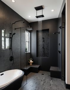 a black and white bathroom with a walk in shower