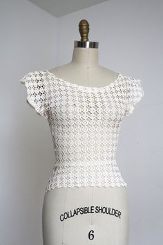 "The prettiest little crochet lace blouse from the 1940s. Metal zipper on the side.  *I will say the photos makes the blouse look a little brighter white than it is in person. Label: none - likely homemade Measurements: { xxsmall } Bust: 30\"-33\" (but did fit dress form with 34.5\" bust)  Waist: 23\"-27\"  Length: about 20\" Sleeve Length: 3.5\" Condition: excellent vintage condition with minor signs of wear - sold as found. washed and ready to wear ☆Shop☆ http://www.trunkofdresses.com/" Vintage White Lace Crochet Top, White Vintage Lace Crochet Top, Fitted Cotton Lace Tops With Crochet Trim, Fitted White Lace Top With Crochet Trim, Vintage White Crochet Lace Top, Vintage White Tops With Crochet Lace, Vintage White Top With Crochet Lace, Fitted White Crochet Lace Top, Vintage Fitted White Lace Top