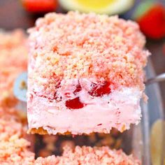 strawberry shortcakes are stacked on top of each other in a glass dish with strawberries around the edges