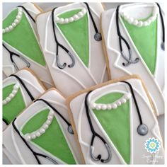 decorated cookies with green and white icing on top of each other, including a doctor's stethoscope