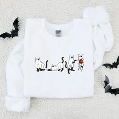 FREE SHIPPING On U.S. orders over $50.00! Use coupon code FREEOVER50 Ready for Spooky Season?! This Halloween Sweatshirt is exactly what you've been looking for! Our unisex heavy blend crewneck sweatshirt is pure comfort. These garments are made from polyester and cotton. This combination helps designs come out looking fresh and beautiful. The collar is ribbed knit, so it retains its shape even after washing. There are no itchy side seams on these sweaters. * 50% cotton, 50% polyester * Pre-shru White T-shirt With Cat Print For Fall, Halloween Cat Print Crew Neck Sweatshirt, White Cat Design Sweatshirt For Fall, White Crew Neck Sweatshirt With Cat Design, White Cat Print T-shirt For Fall, White Cat Design Top For Fall, White T-shirt With Cat Design For Fall, Skeletons Halloween, Funny Dancing