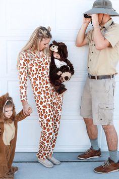 a man and two children dressed in animal onesuits