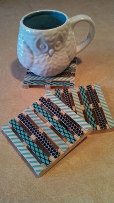 an owl mug and coasters on a table