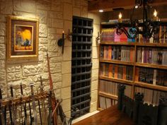 a room filled with lots of books on shelves next to a wall mounted book case