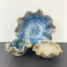 A beautiful collection of studio hand crafted pottery bowls in the shape of a leaf with hand finished ruffled edges, by Dellorden Pottery. These clam shell style dishes are evidently hand crafted, one large and 2 smaller bowls in blues and sandy colours. Nature inspired pottery to use anywhere around the home or for display. Dellorden Pottery is imprinted on the base.  Set of 3. Excellent condition. Measures approx.  Large Bowl 260mm (diam.) x 80mm (H) Small blue bowl 150mm (diam.) x 65mm (H) Sm Pottery Leaf, Leaf Bowl, Decorative Leaves, Leaf Bowls, Blue Bowl, Clam Shell, Dish Sets, Studio Pottery, Pottery Bowls