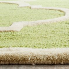 a green and white rug on the floor