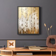 an abstract painting hangs on the wall above a coffee table