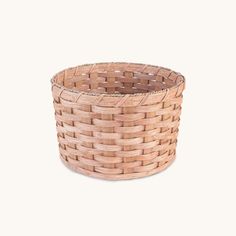 a round basket made out of wood with woven linings on the bottom and sides