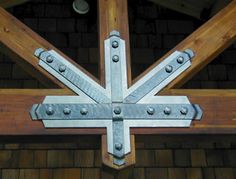 the metal cross is attached to the wooden structure