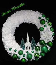 a wreath with green and white ornaments around it on a black background that says sweet wheats