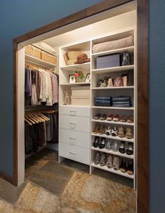 an open closet with shoes and other items