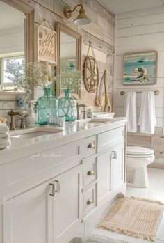 a bathroom with two sinks and mirrors on the wall next to a toilet in it