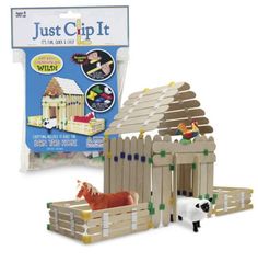 a wooden toy set with a fence and horse in the yard next to it's packaging