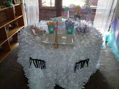 the table is decorated with tissue pom poms