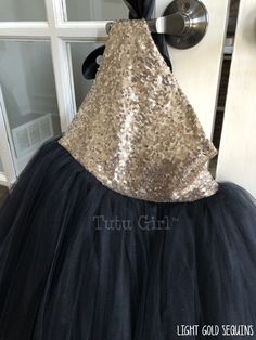 "Such a striking tulle dress! It's created in our true gold sequins with a black ribbon tie and black tulle skirt. The dress opens and closes at the top of the right shoulder. The bodice is fully lined. We offer the following sequin colors: gold, light gold, rose gold, blush pink, champagne, silver, white and black WANT A SEWN IN SLIP TO LINE THE TUTU? https://www.etsy.com/listing/125566641/add-a-slip-to-the-tutu-dress-sewn-in At checkout, please give us the following information: HOW TO ORDER: Glamorous Gold Tulle Dresses, Holiday Party Tulle Tutu Dress, Holiday Party Tutu Dress Made Of Tulle, Holiday Tulle Tutu Dress With Sequins, Holiday Sequined Tulle Tutu Dress, Holiday Tutu Dress With Sequins, Gold Dress For Holiday Costume Party, Gold Dress For Costume Party And Holiday, Gold Dresses For Holiday Costume Party