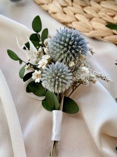 a bouquet of flowers sitting on top of a white cloth